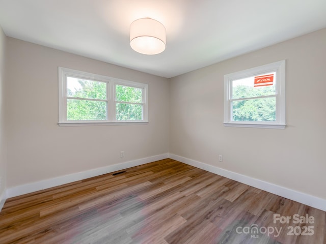 1606 N Rhyne St, Gastonia, NC 28054 - spare room with baseboards and wood finished floors