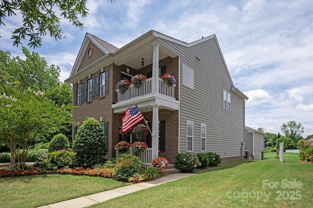 10818 Alvarado Way, Charlotte, NC 28277 - view of front of home featuring a balcony, brick siding, and a front lawn