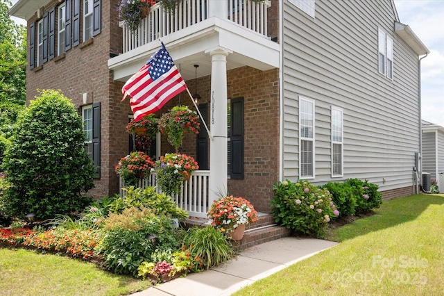 10818 Alvarado Way, Charlotte, NC 28277 - view of home's exterior featuring a lawn, covered porch, brick siding, and a balcony