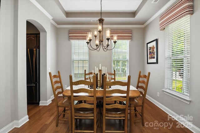 10818 Alvarado Way, Charlotte, NC 28277 - dining room with a chandelier, dark wood-type flooring, a raised ceiling, arched walkways, and ornamental molding