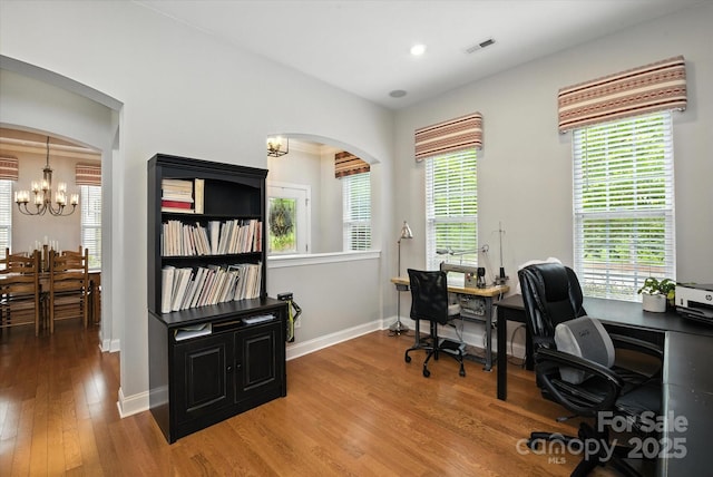 10818 Alvarado Way, Charlotte, NC 28277 - office with a chandelier, wood finished floors, arched walkways, healthy amount of natural light, and recessed lighting
