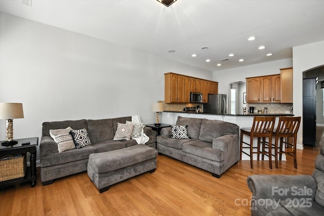 10818 Alvarado Way, Charlotte, NC 28277 - living area featuring arched walkways, light wood-style floors, and recessed lighting