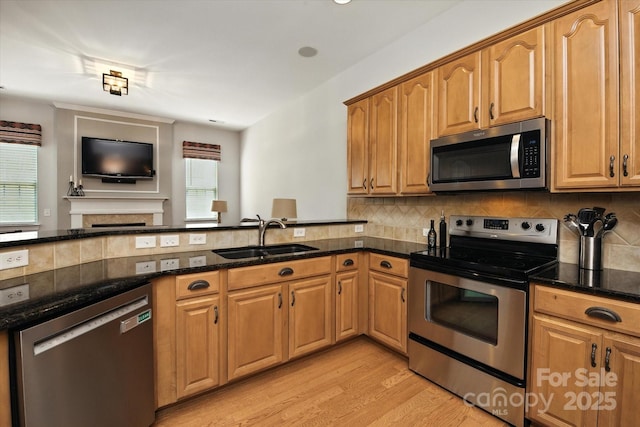 10818 Alvarado Way, Charlotte, NC 28277 - kitchen with stainless steel appliances, dark stone countertops, light wood-style floors, decorative backsplash, and open floor plan