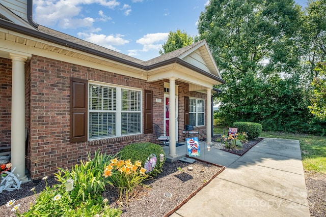 2773 Clover Rd NW, Concord, NC 28027 - view of exterior entry featuring brick siding and a porch