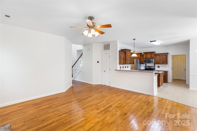1581 Bluff Ct, Rock Hill, SC 29732 - unfurnished living room featuring light wood-type flooring, stairway, and a ceiling fan