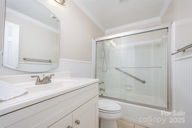 1300 Reece Rd Unit 402, Charlotte, NC 28209 - full bath with vanity, ornamental molding, shower / bath combination with glass door, wainscoting, and tile patterned floors