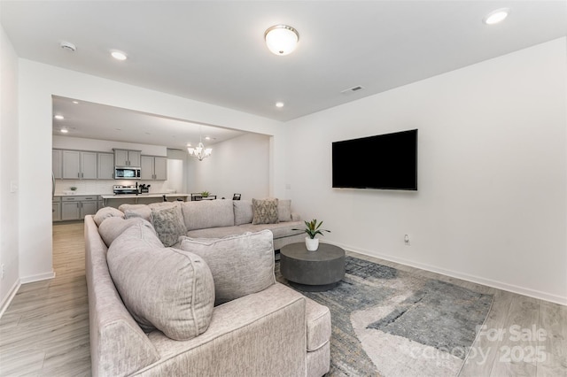 5010 Arbordale Way, Mount Holly, NC 28120 - living room featuring light wood-style flooring, a chandelier, and recessed lighting