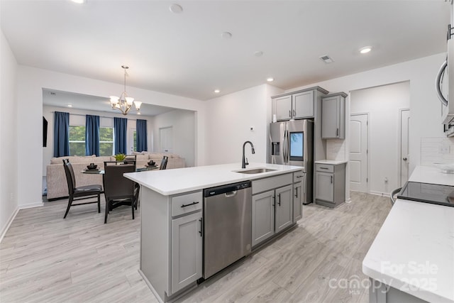 5010 Arbordale Way, Mount Holly, NC 28120 - kitchen featuring stainless steel appliances, gray cabinetry, a chandelier, light wood-type flooring, and recessed lighting
