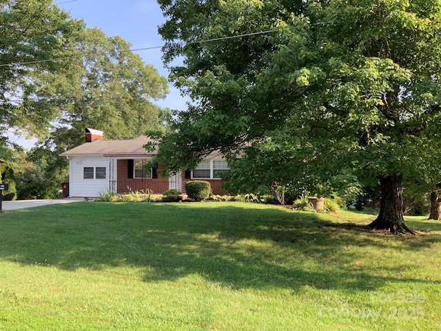 3009 Grier St, Newton, NC 28658 - view of front of house with a front lawn, a chimney, and brick siding