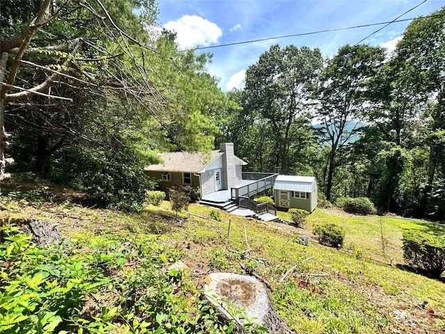 123 Avondale Ridge Rd, Asheville, NC 28803 - view of grassy yard featuring a storage unit and a deck