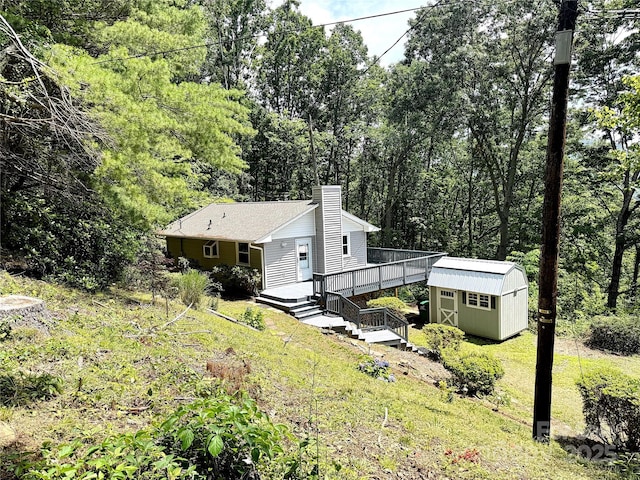 123 Avondale Ridge Rd, Asheville, NC 28803 - view of front of house featuring a shed, a chimney, a wooden deck, a front yard, and a wooded view