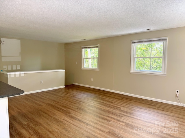 123 Avondale Ridge Rd, Asheville, NC 28803 - unfurnished room with a textured ceiling and wood finished floors