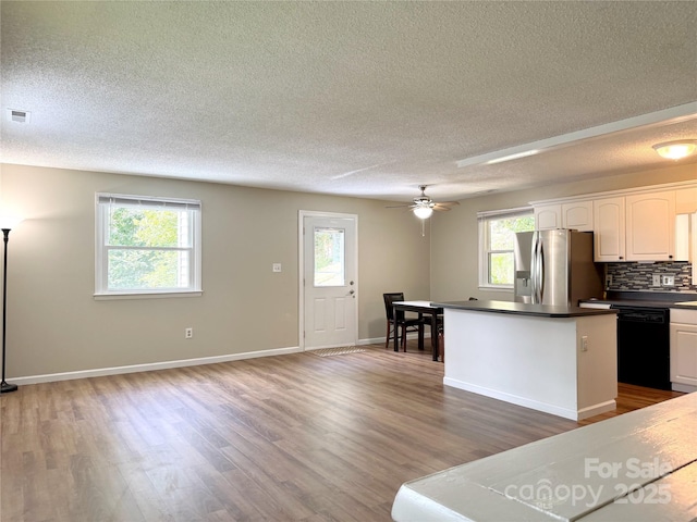 123 Avondale Ridge Rd, Asheville, NC 28803 - kitchen featuring stainless steel fridge, dishwasher, a textured ceiling, dark countertops, and a kitchen island