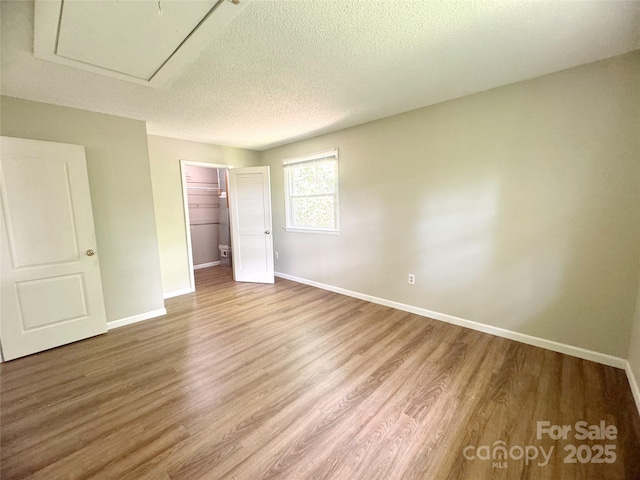 123 Avondale Ridge Rd, Asheville, NC 28803 - unfurnished bedroom featuring wood finished floors, a textured ceiling, and a closet