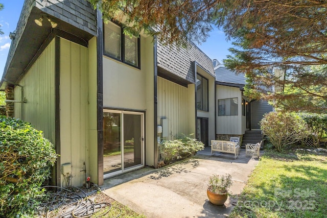 4208 Burning Tree Dr, Charlotte, NC 28277 - view of exterior entry with mansard roof and a patio