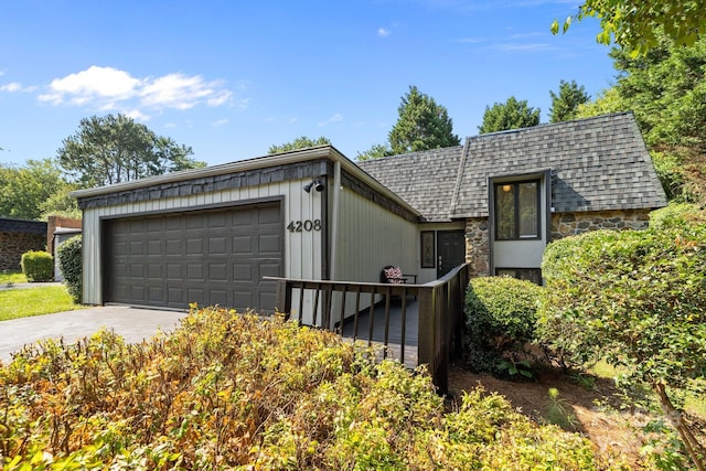 4208 Burning Tree Dr, Charlotte, NC 28277 - view of front of home featuring a shingled roof, an attached garage, concrete driveway, and stone siding