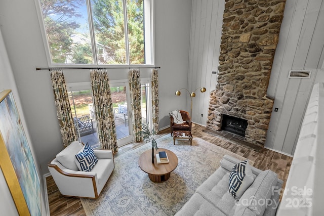 4208 Burning Tree Dr, Charlotte, NC 28277 - living room featuring wood finished floors, a high ceiling, and a fireplace