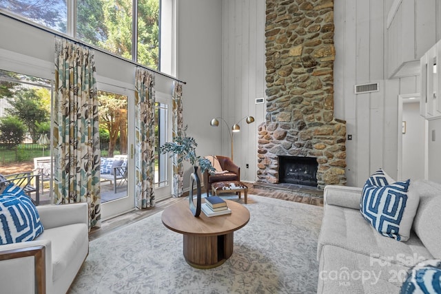 4208 Burning Tree Dr, Charlotte, NC 28277 - living room featuring a towering ceiling, wood finished floors, and a fireplace