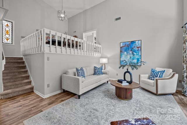 4208 Burning Tree Dr, Charlotte, NC 28277 - living area featuring high vaulted ceiling, wood finished floors, and stairway