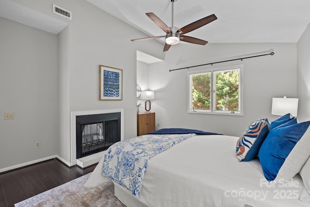 4208 Burning Tree Dr, Charlotte, NC 28277 - bedroom featuring vaulted ceiling, wood finished floors, a fireplace, and ceiling fan