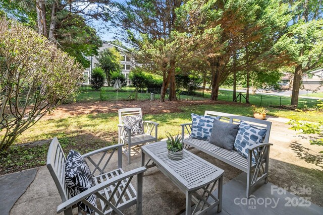 4208 Burning Tree Dr, Charlotte, NC 28277 - fenced backyard with a patio and outdoor lounge area