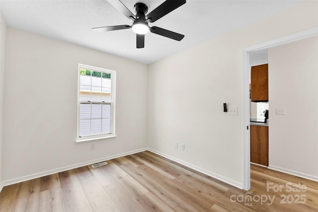 400 N Main Gq St, Granite Quarry, NC 28146 - spare room with light wood finished floors and a ceiling fan