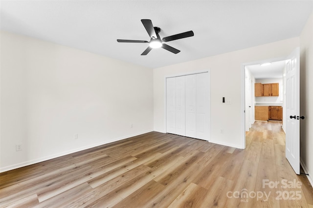 400 N Main Gq St, Granite Quarry, NC 28146 - unfurnished bedroom featuring light wood-style flooring, a closet, and a ceiling fan
