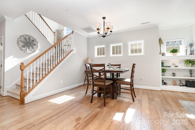3899 Zemosa Ln NW, Concord, NC 28027 - dining room with stairway, ornamental molding, wood finished floors, and a chandelier