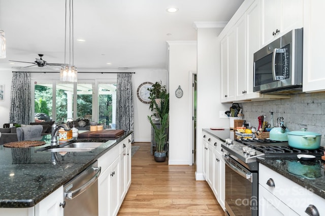 3899 Zemosa Ln NW, Concord, NC 28027 - kitchen featuring stainless steel appliances, crown molding, light wood-type flooring, ceiling fan, and decorative backsplash