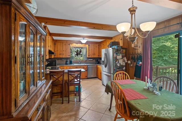 6632 Candlewood Dr, Charlotte, NC 28210 - kitchen with appliances with stainless steel finishes, a chandelier, light tile patterned flooring, light countertops, and beamed ceiling