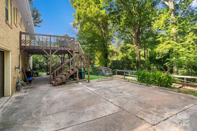 6632 Candlewood Dr, Charlotte, NC 28210 - view of patio with a storage unit, a wooden deck, stairway, and view of wooded area