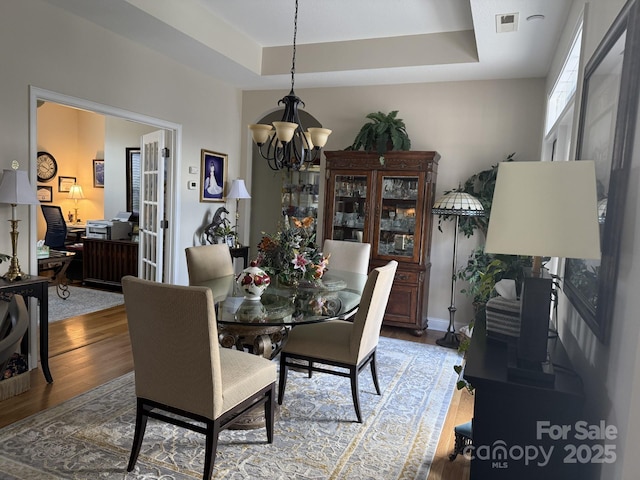 860 Wynnshire Dr, Hickory, NC 28601 - dining room with a chandelier, wood finished floors, a raised ceiling, and an office area