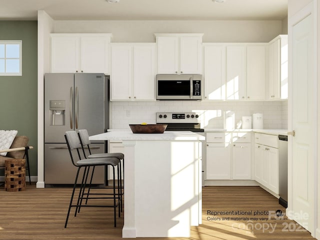 241 Runner Stone Ln, Fort Mill, SC 29715 - kitchen featuring stainless steel appliances, a kitchen island, dark wood finished floors, and white cabinetry