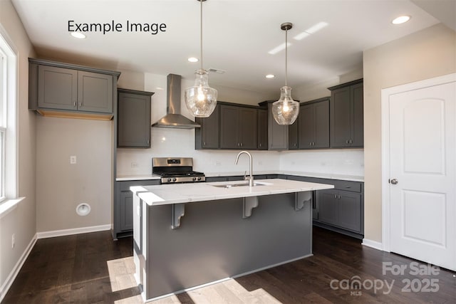 6140 Balham Ct Unit Ken0059, Charlotte, NC 28215 - kitchen with wall chimney exhaust hood, stainless steel range, decorative backsplash, dark wood-style floors, and a breakfast bar