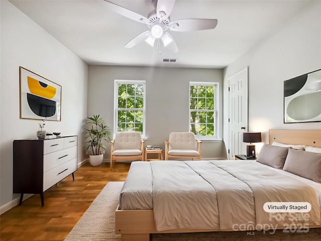 8701 Holly Creek Ct, Charlotte, NC 28216 - bedroom featuring multiple windows, wood finished floors, and a ceiling fan