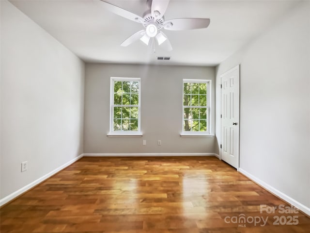 8701 Holly Creek Ct, Charlotte, NC 28216 - empty room with a ceiling fan and wood finished floors