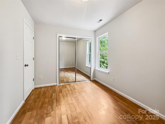 8701 Holly Creek Ct, Charlotte, NC 28216 - unfurnished bedroom with wood finished floors and a closet