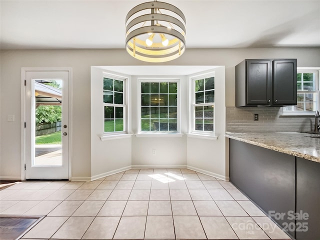 8701 Holly Creek Ct, Charlotte, NC 28216 - unfurnished dining area with healthy amount of natural light and light tile patterned floors