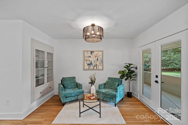 4209 Windwood Cir, Charlotte, NC 28226 - sitting room with french doors, light wood-style floors, and a chandelier