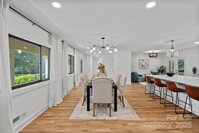 4209 Windwood Cir, Charlotte, NC 28226 - dining area featuring plenty of natural light, recessed lighting, light wood-style floors, and a chandelier