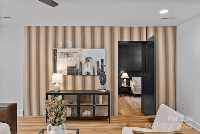 4209 Windwood Cir, Charlotte, NC 28226 - sitting room with an accent wall, wood finished floors, and ceiling fan