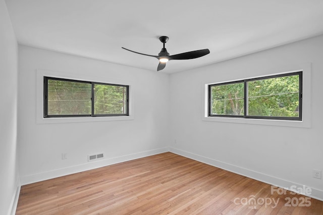 4209 Windwood Cir, Charlotte, NC 28226 - empty room featuring healthy amount of natural light, light wood finished floors, and ceiling fan