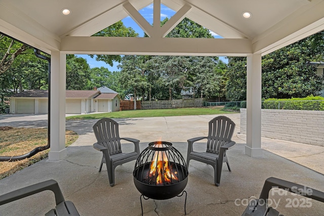 4209 Windwood Cir, Charlotte, NC 28226 - view of patio featuring a fire pit, an outdoor structure, and view of wooded area