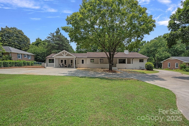 4209 Windwood Cir, Charlotte, NC 28226 - view of front facade with concrete driveway, a front lawn, and a chimney