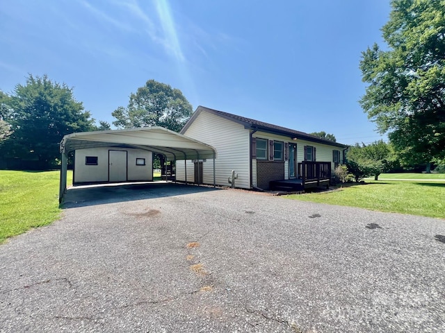 1678 Nelson Dr, Newton, NC 28658 - view of front facade featuring a front lawn, driveway, and a carport