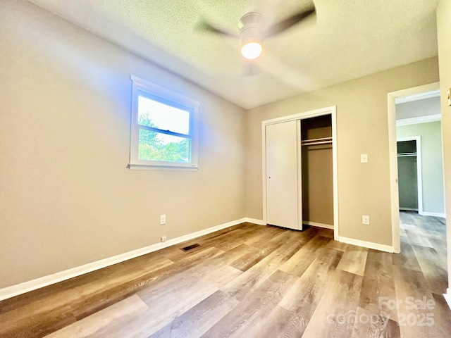 1678 Nelson Dr, Newton, NC 28658 - unfurnished bedroom with wood finished floors, a closet, a textured ceiling, and ceiling fan