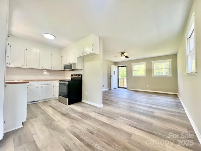 1678 Nelson Dr, Newton, NC 28658 - kitchen with appliances with stainless steel finishes, light wood finished floors, white cabinets, and ceiling fan