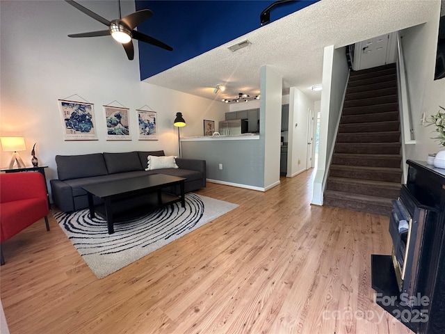 215 Linkside Ct SE, Lenoir, NC 28645 - living room featuring ceiling fan, wood finished floors, stairway, a textured ceiling, and track lighting