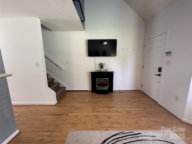 215 Linkside Ct SE, Lenoir, NC 28645 - unfurnished living room featuring light wood finished floors and stairway
