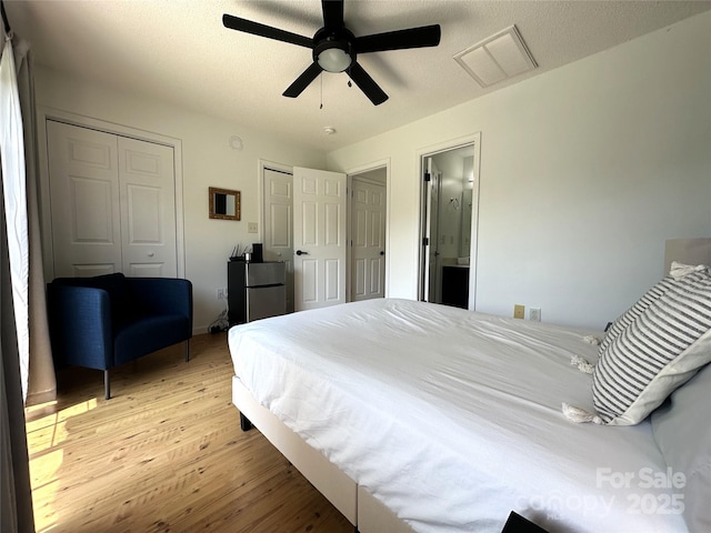 215 Linkside Ct SE, Lenoir, NC 28645 - bedroom with light wood-type flooring, multiple closets, and ceiling fan